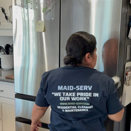 Get in touch with Maid-Serv Cleaning Services – Professional Maid Cleaning Contact Maid-Serv Cleaning Services in Salt Lake, Utah, maid cleaning a refrigerator during a home cleaning service